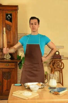 Man in the kitchen with rolling pin Stock Photos