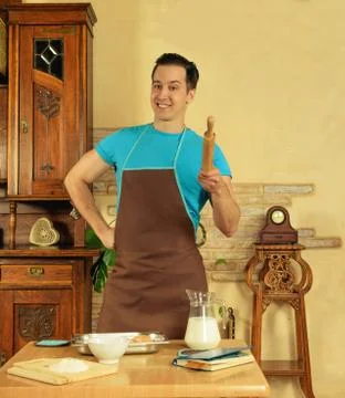 Man in the kitchen with rolling pin Stock Photos