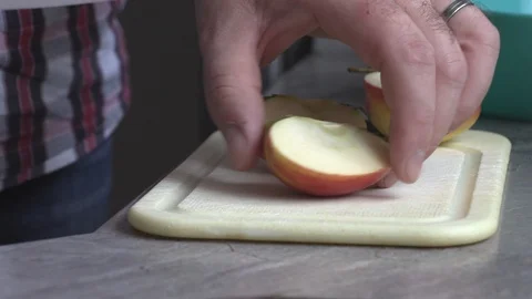 A man in the kitchen slicing an apple Stock-Footage 95636414