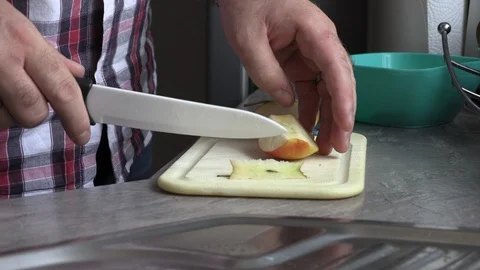 A man in the kitchen slicing an apple Stock Footage 95644431