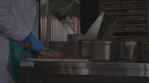 Man in Kitchen Slicing Tomatoes with Sharp Knife Stock Footage 115861742
