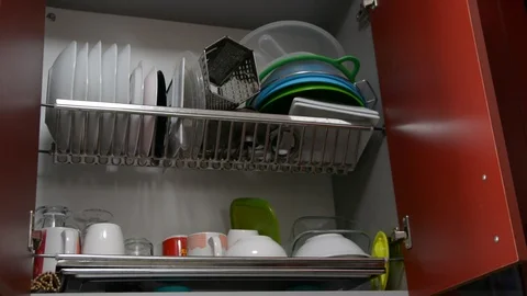 Man in kitchen stack clean dishes 스톡 동영상 95657421