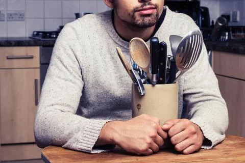 Man with kitchen utensils Stock Photos