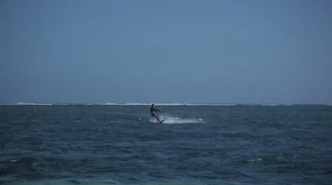 Man kite surfing towards camera and sprays water Stock Footage 64595184