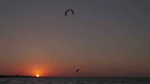 Man on the kiteboard rides in the evening Stock Footage 208398786