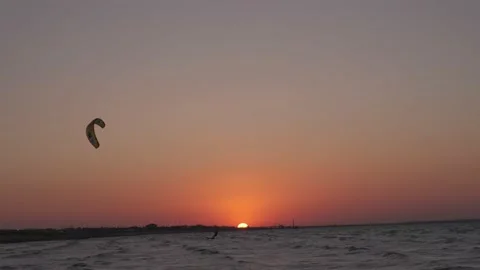Man on the kiteboard rides in the evening Stock Footage 208403581
