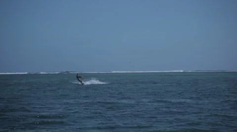 Man kitesurfing towards and away from camera Stock Footage 64595053