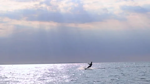 A man kitesurfs and performs complex elements of jumping on the waves Stock Footage 311932259