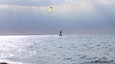 A man kitesurfs bouncing on the waves of the Baltic Sea Video stock 311923185