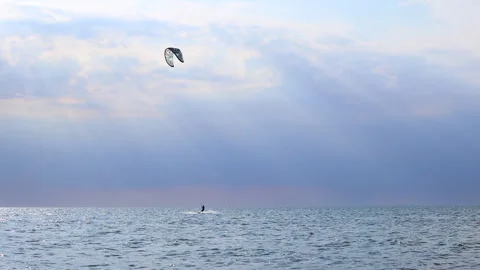 A man kitesurfs bouncing on the waves of the Baltic Sea Stock Footage 311924665
