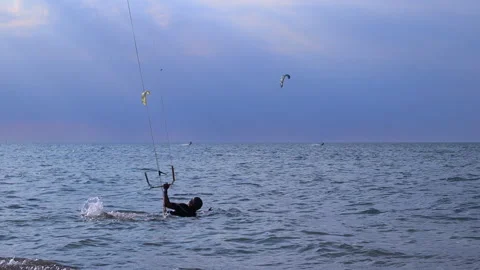 A man kitesurfs bouncing on the waves of the Baltic Sea Video stock 311924668