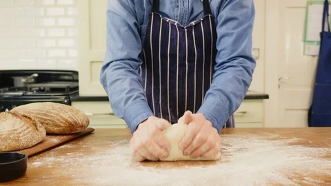 Man Kneading Dough And Spreading Flour On Table At Home Stock Footage 86074548