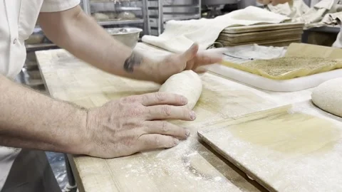 Man Kneading Dough in a Bakery Video stock 263408833