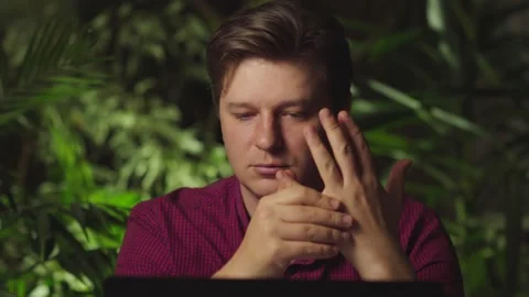 Man kneading his fingers while sitting at the computer Stock Footage 149032593