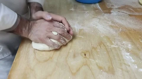 A man kneads dough Stock Footage 164390243