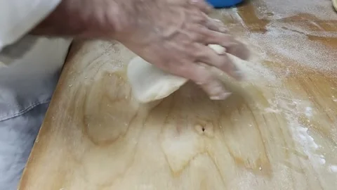 A man kneads dough Stock Footage 164390593