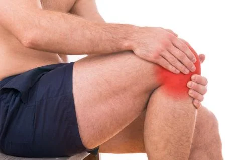 Man with knee pain over white background Stock Photos