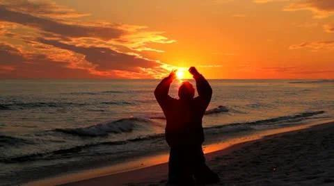 Man Kneeling At Sunset Stock Footage 10721199