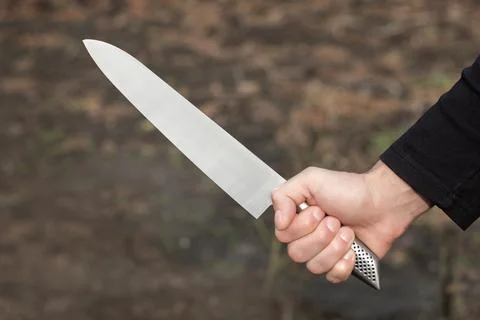 The man with a knife in a hand. Closeup Stock Photos