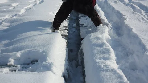 Man knocks axe ice cover on the roof Stock Footage 70011067