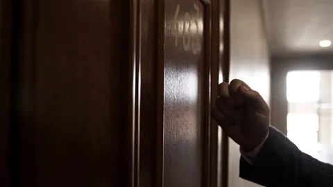 A man knocks on a hotel room number 403 Stock Footage 129260210