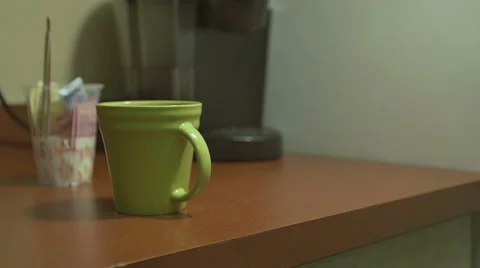 Man Knocks Over Coffee Mug Stock Footage 56393911