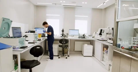 Man laboratory assistant analyzing blood sample and determinate type and rhesus Stock Footage 259728409