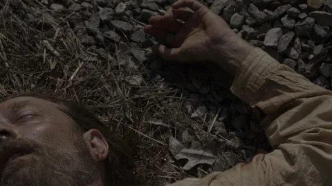 Man, laborer lying dead next to RailRoad tracks - 1800s Western Portrayal Video stock 106144322