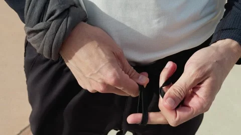 Man Lacing The Pants Before Workout Stock Footage 276185069