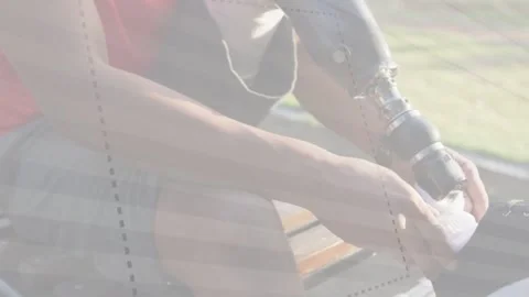 Man lacing sneaker and checking prosthetic knee socket on park bench, preparing Stock Footage 333575425