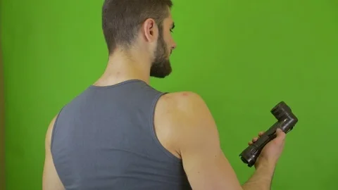 A man with a lamp examines the area on a green screen Stock Footage 75910343