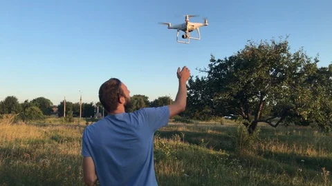 Man lands Phantom 4 Pro into his hand. Hand catch of Phantom 4 Pro. Stock Footage 93305568