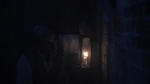 Man with a lantern in Dark, Haunted Environment Stock Footage 100475897