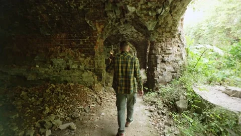 A man with a lantern in the dungeon Stock Footage 234786017