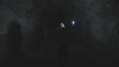 A man with a lantern in the dungeon Stock Footage 235035349