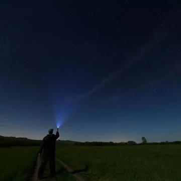 Man lantern illuminates the dark starry sky. Photographed by the moonlight. Stock Photos