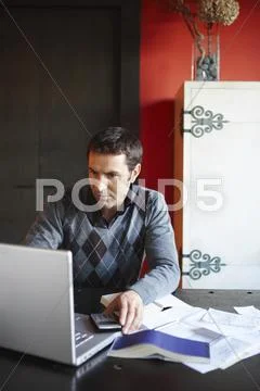 Man With Laptop And Paperwork