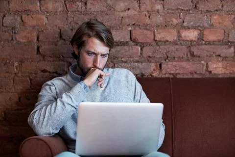 Man, laptop and thinking for remote work in home, insight or inspiration for Stock Photos