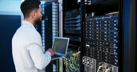 Man, laptop and typing for programming in server room, hardware and inspection Stock-Fotos
