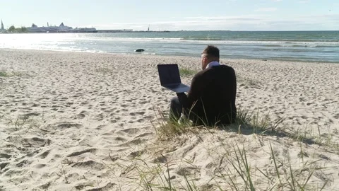 Man with laptop on beach Stock Footage 134164830