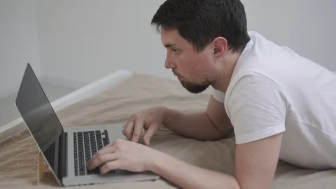 Man with a laptop in bed. Stock Footage 90896691
