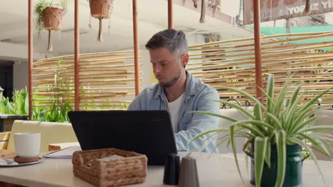 A man with a laptop in a cafe Stock-Footage 308736489