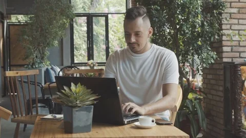Man with laptop computer start new business project at cafe. Young businessman. Stock Footage 76492022