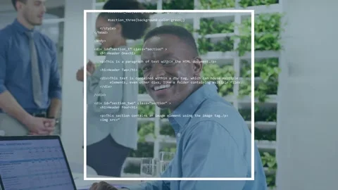 Man at laptop glancing up as animated code overlay building around him, smiling Stock Footage 334351738