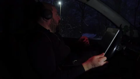 Man with laptop in his car working in the night Video stock 146464367