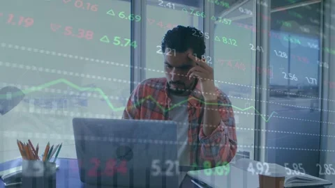 Man at laptop seeing data overlay reading markets deciding trades charts arrows Stock Footage 335762070