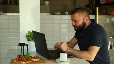 Man with laptop sitting in the restaurant Stock Footage 67993708