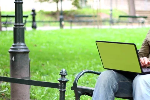 Man with laptop talking on mobile phone, dolly shot Stock Footage