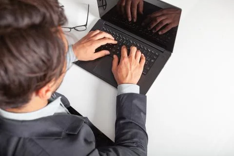 Man with laptop typing on the keyboard doing a search. Stock Photos