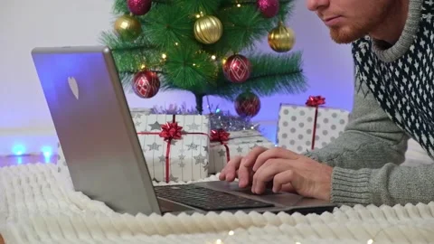 Man with laptop working, studying remotely new year 2023, Christmas. Remote work Stock Footage 221601898